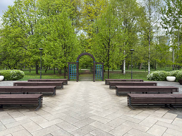 istock Well maintained public park area with symmetrical benches 2228239012
