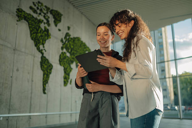 istock Two female colleagues sharing a digital tablet in a modern office 2228240425