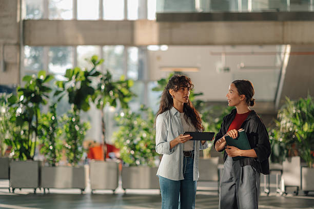 istock Two young businesswomen discussing work in modern office 2228240462