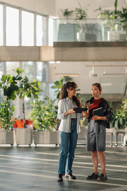 istock Two young businesswomen discussing a project on a digital tablet in a modern office 2228240465