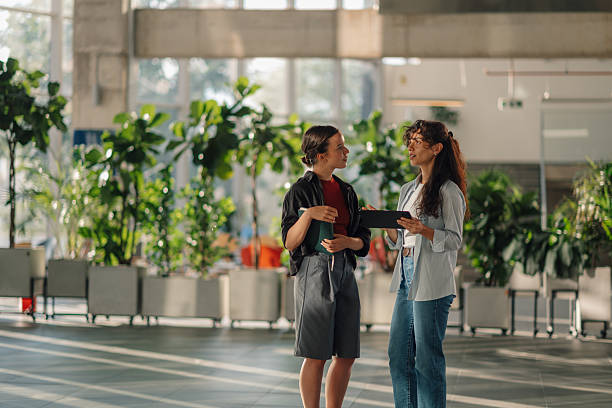 istock Two young businesswomen discussing a project using a tablet in a modern office 2228240469