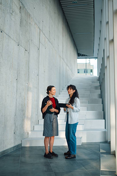 istock Two young women discussing a project in a modern office building 2228240490
