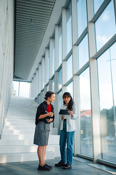 istock Two young businesswomen collaborating on a digital tablet in a modern office 2228240494