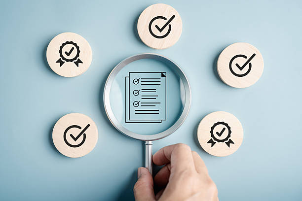 istock Quality management and certificate approval checklist document under magnifying glass, representing compliance, auditing, standardization, and verification process. 2228249568