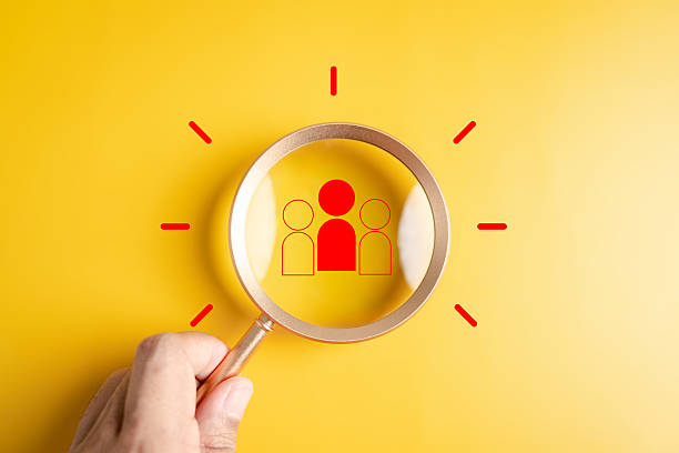 Teamwork and startup idea concept with magnifying glass focusing, team building, talent search, collaboration, and innovative business development.