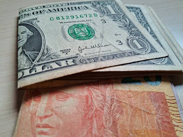 istock Folded dollar and real bills on a light wooden table 2228255056