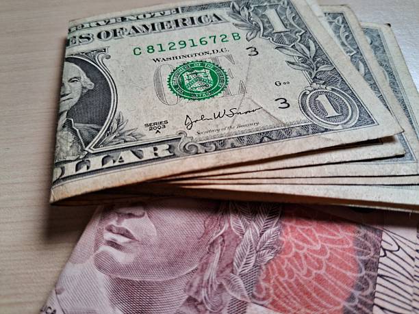 istock Folded dollar and real bills on a light wooden table 2228255573