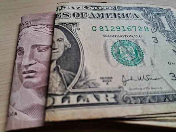 istock Folded dollar and real bills on a light wooden table 2228255598