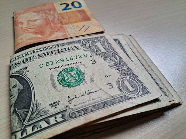 istock Folded dollar and real bills on a light wooden table 2228255629