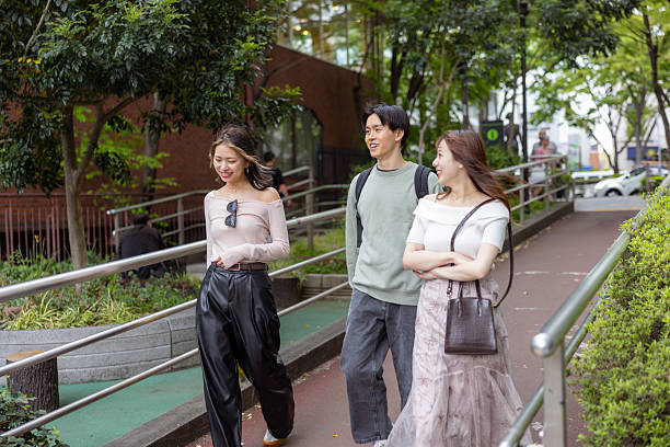 istock Young friends walking together in city 2228261087
