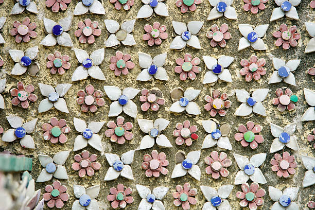 This image showcases a detailed decorative wall adorned with intricate floral patterns made from colorful tiles, blending artistry with the elegance of design.