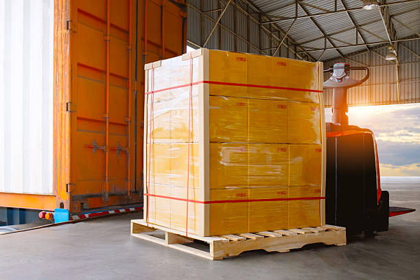 istock Bulk of Package Boxes Waiting to be Loaded into Containers Trucks. Distribution Shipping Cargo Container. Semi Trailer Trucks on The Parking Lot at Sunset. Freight Truck Logistics Transport. 2228268040