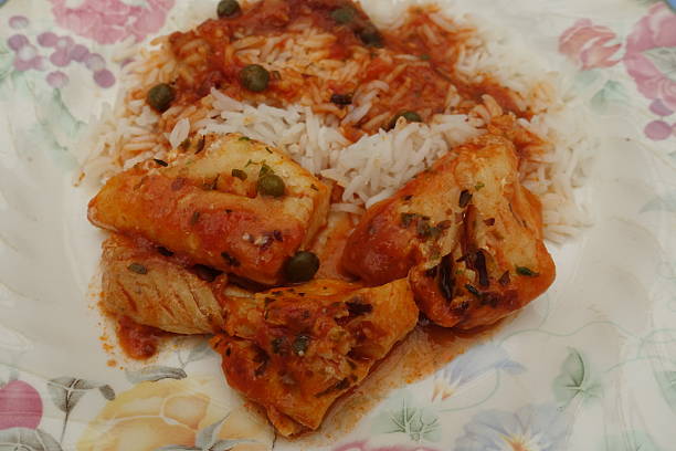 istock Cod stew in tomato sauce with capers and dried seaweed served with basmati rice 2228272154