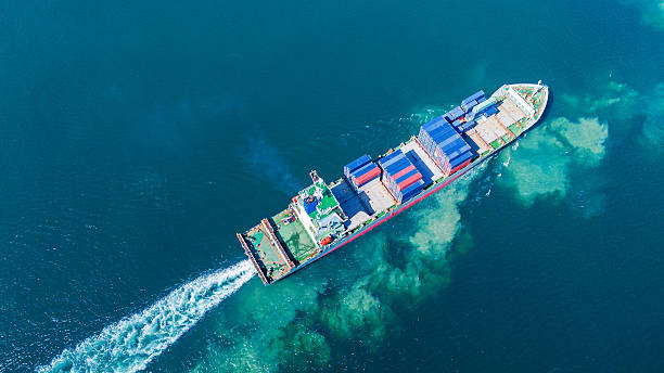 istock Aerial of cargo ship carrying container and running verry fast for export cargo from cargo yard port to other ocean concept smart freight shipping ship top view 2228272695