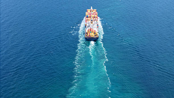 istock Aerial of cargo ship carrying container and running verry fast for export cargo from cargo yard port to other ocean concept smart freight shipping ship stern view 2228272812