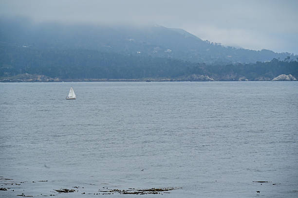 istock Lone Single Sailboat sailing slowly on the ocean 2228273353