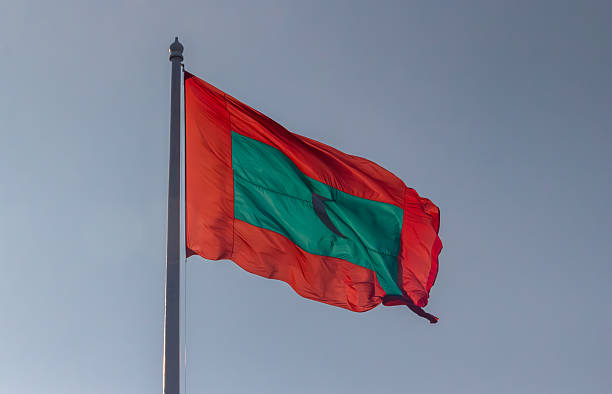 istock Maldivian flag waves against a clear sky. 2228274296