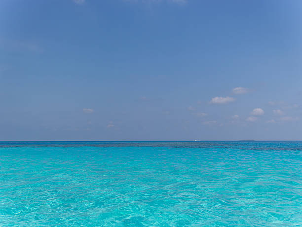 istock Clear ocean meets vast blue sky 2228275226