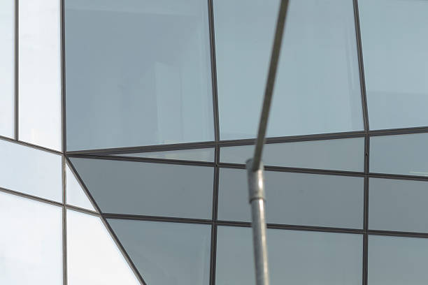 istock A tall building featuring numerous windows and a pole standing in front of it 2228279970