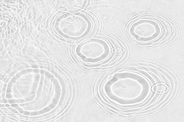 istock White water with ripples on the surface. Defocus blurred transparent white colored clear calm water surface texture with splashes and bubbles. Water waves with shining pattern texture background. 2228280734