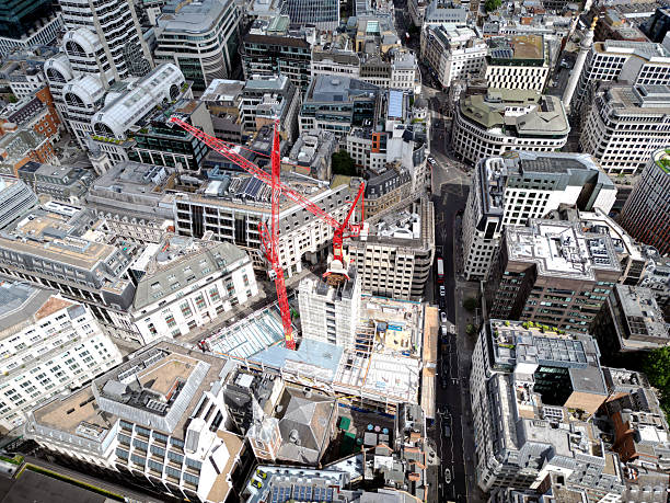 A construction site dominated by cranes, emphasizing growth and the evolution of the urban landscape in modern cities in London, UK. City of London.