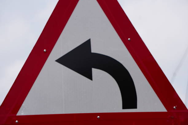 An informative traffic signage board indicating left-hand bend ahead