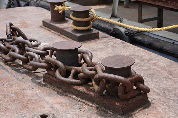 istock Rusted Metal Chain and Turnbuckle Securing Mechanism on Ship Deck in Marine Environment 2228282933