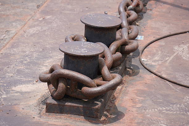 istock A heavy-duty anchor chain wrapped around two bollards on what appears to be a ship's deck or a dock 2228283032