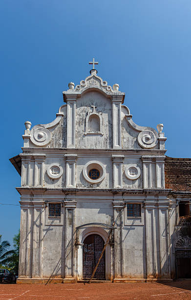 istock Old Goan church facade under clear blue sky 2228288927