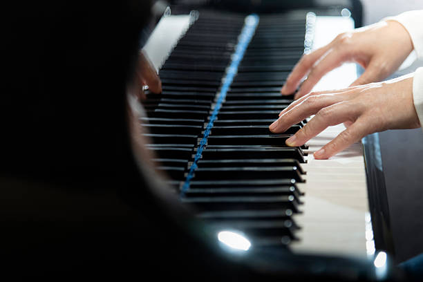 istock Woman's hands playing the piano 2228289291