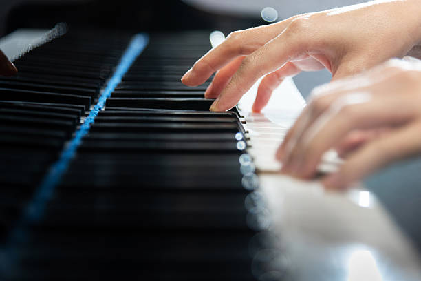 istock Woman's hands playing the piano 2228289298