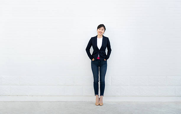 istock Confident woman standing with hands in pockets 2228289469