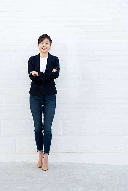 istock Confident woman standing with arms crossed 2228289472