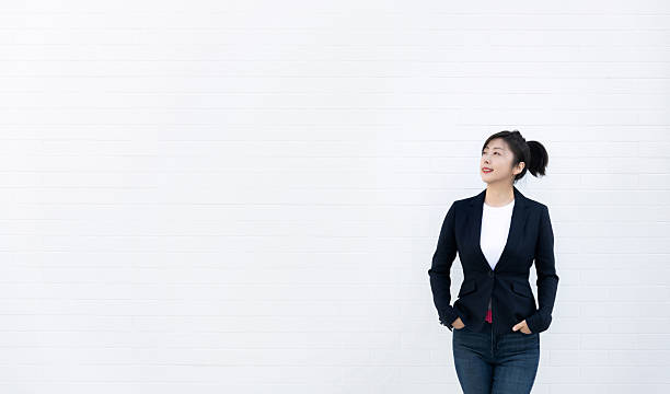 istock Confident woman standing with hands in pockets 2228289473