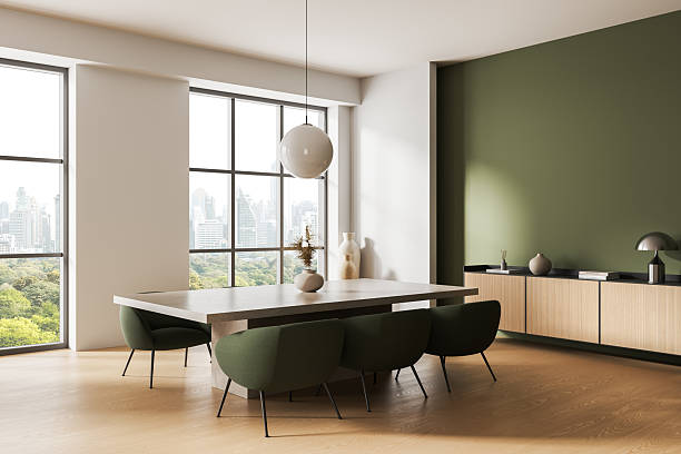 Modern minimalist dining interior with green accent wall and cityscape view through large windows in natural daylight ambiance. 3D Rendering