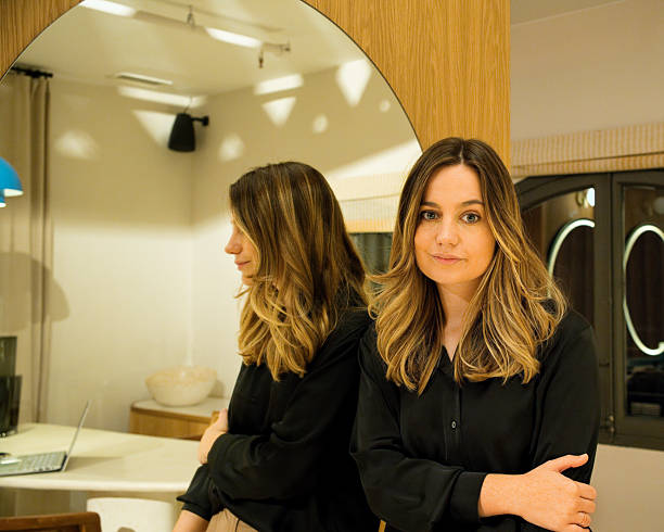 istock Confident Gen Z woman looking at camera with coworking space reflected behind 2228289507