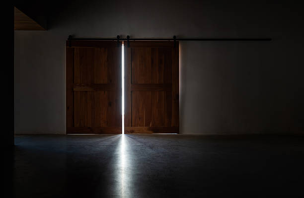 Light in a dark room through the opening door