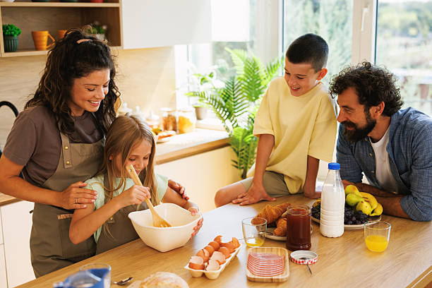 istock Happy family preparing breakfast in kitchen together 2228290868