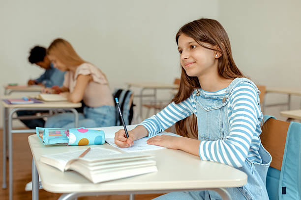 istock Portrait of Smart Elementary Girl Writing in Notebook 2228295771