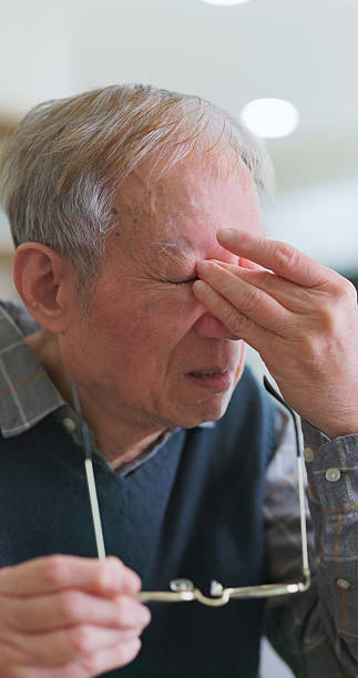 istock Asian elderly rub eyes home 2228296331