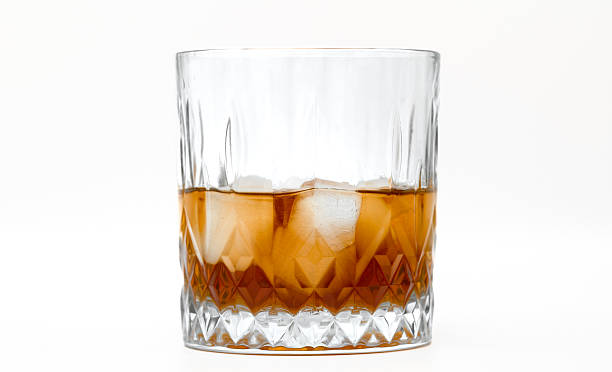 istock Whiskey with ice in a whisky glass isolated on white background 2228297301