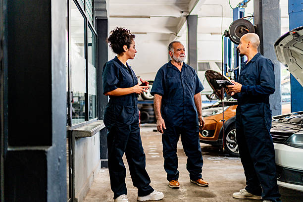 istock Mechanics talking at auto repair shop 2228302382