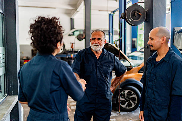 istock Mechanics talking at auto repair shop 2228302398