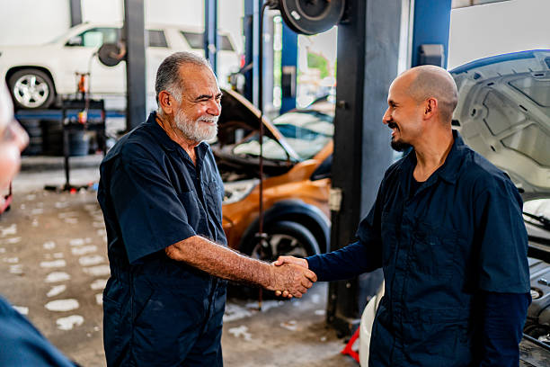 istock Mechanics talking at auto repair shop 2228302403