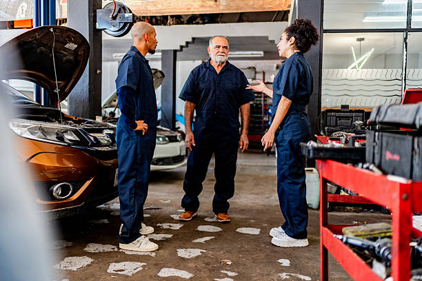 istock Mechanics talking at auto repair shop 2228302417
