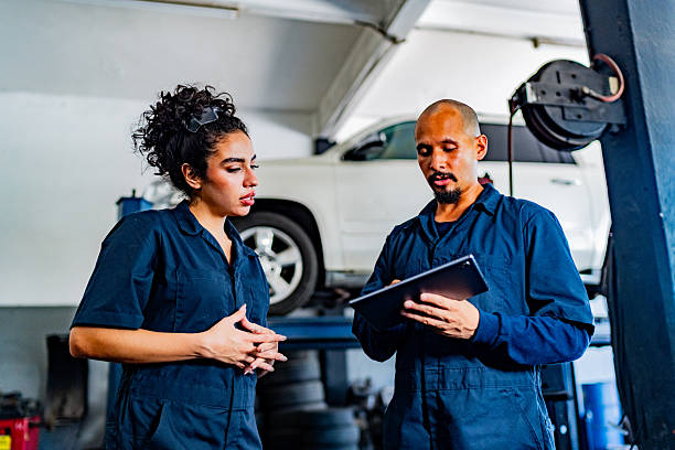 istock Mechanics talking at auto repair shop 2228302666
