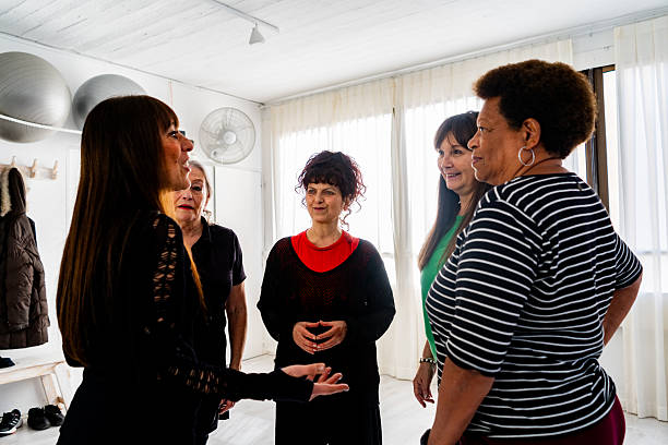 istock Senior dance teacher talking to students during a break at the dance class 2228303085