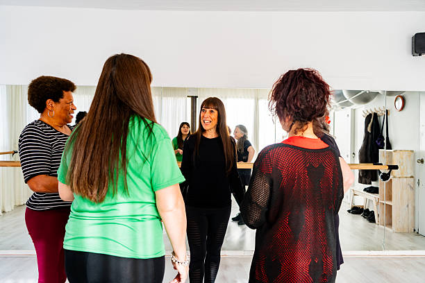istock Senior dance teacher talking to students during a break at the dance class 2228303094