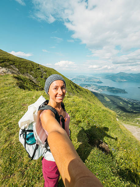 istock Woman Hiking in Mountains Taking Selfie 2228303572