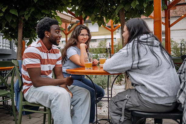 istock Group of friends having drink together at sidewalk cafe while enjoying talking 2228304872